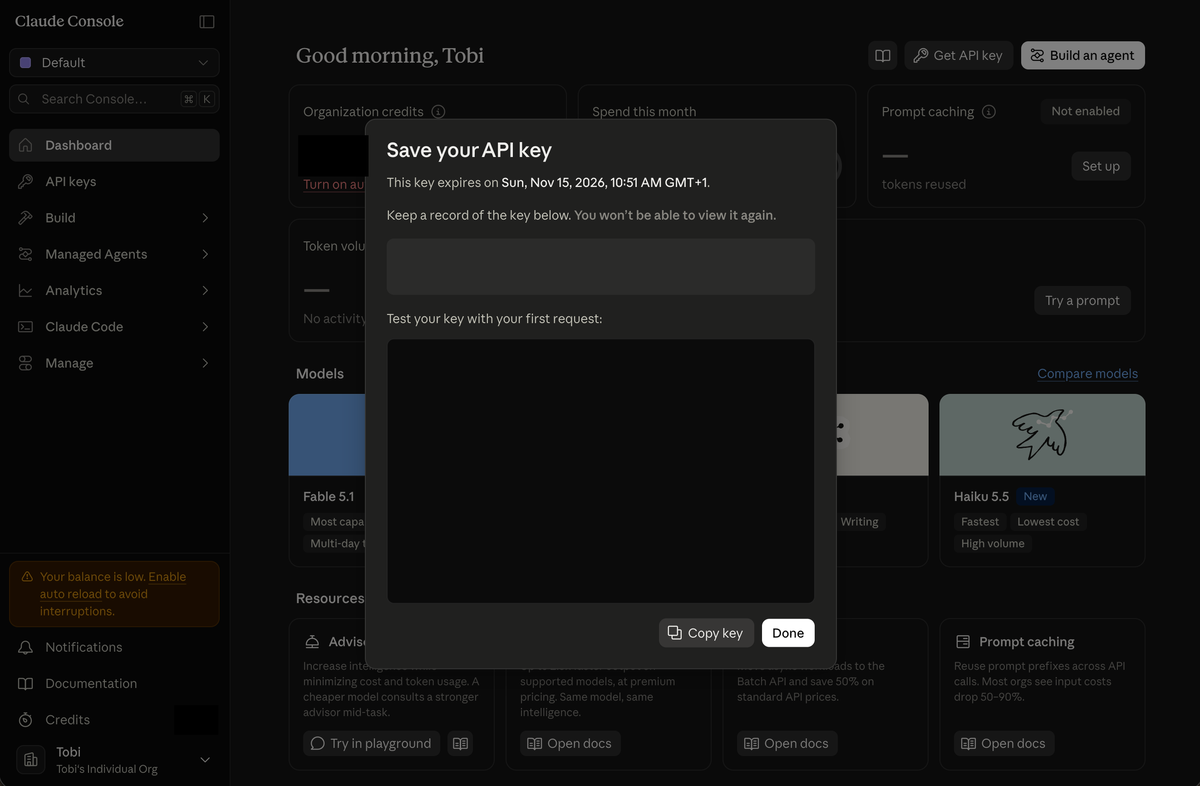 The Save your API key window, with the key covered, a Copy key button and a Done button, and a notice that the key cannot be viewed again.